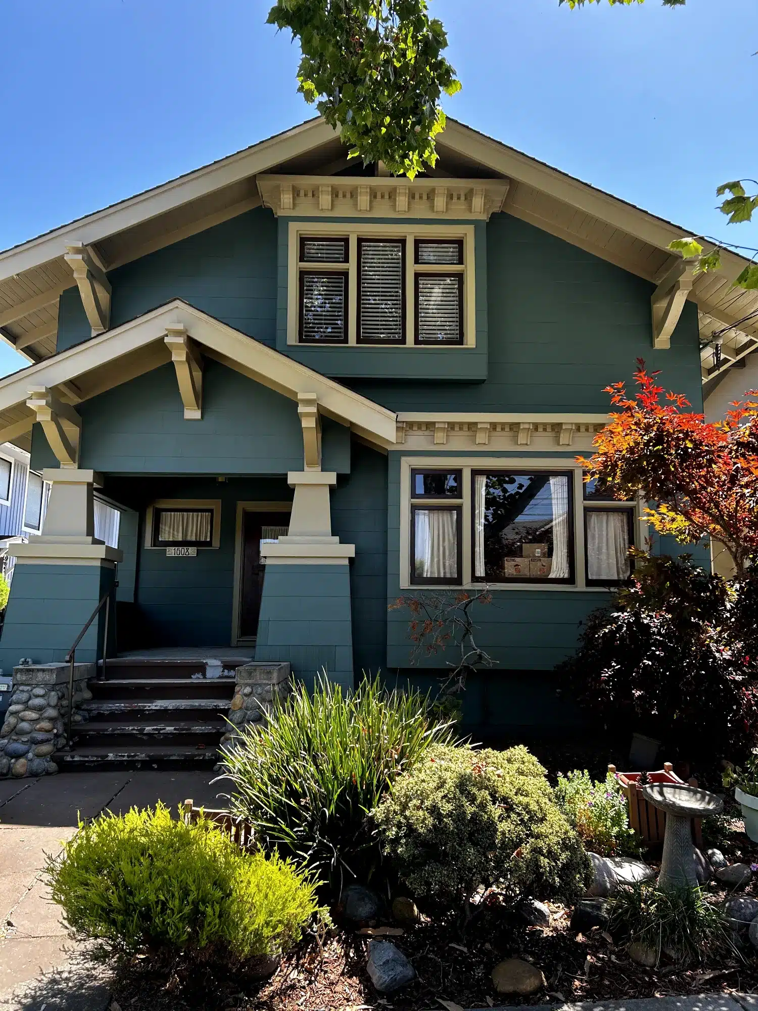 Dark Teal Exterior Residential Home Dark teal-painted exterior residential home with cream trim, black-framed windows, and decorative corbels in Oakland, CA
